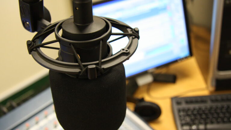 Studio microphone beside computer equipment